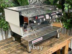 La machine à café expresso La Marzocco Linea Classic 2 Group, blanche, avec pieds hauts, pour café.
