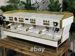 La machine à café expresso La Marzocco Linea Pb 4 Group avec poignées blanches et dorées pour café.